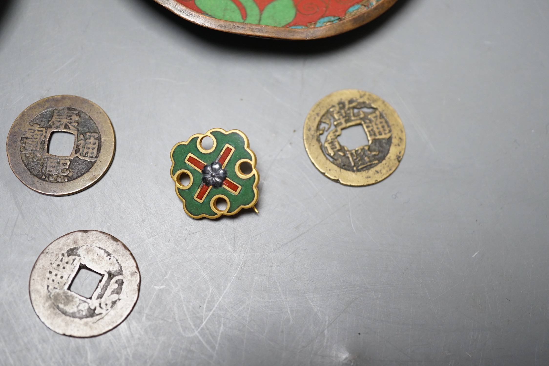 A group of Chinese coins, cloisonné enamel wares and an enamelled badge